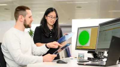 Huschitt and Suba looking at a monitor.