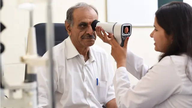 An eye of a man gets examined with a Bosch Eye Care Solution device.