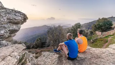 Till Schenk and his running buddy Elly sit on a rock and look up at the evening sky.