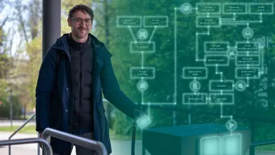 Enrico enters the Bosch premises by holding his company ID card up to the card reader. He smiles at the camera.