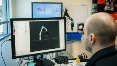 Student at Bosch Research and Technology Center working with a robot