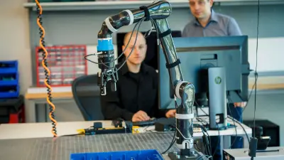 Students at Bosch Research and Technology Center working with a robot