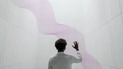 A man in front of a gray wall