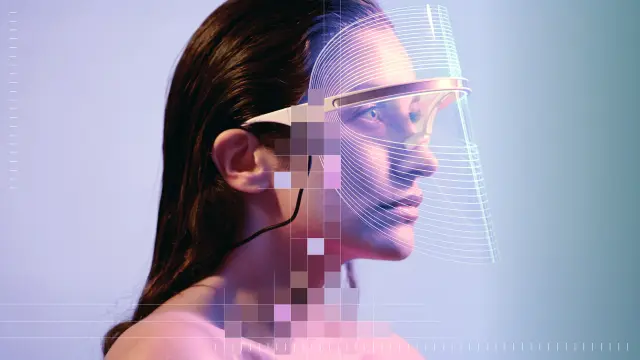 A person wearing a futuristic headset looks ahead. Parts of the image are overlaid with colorful pixel blocks.