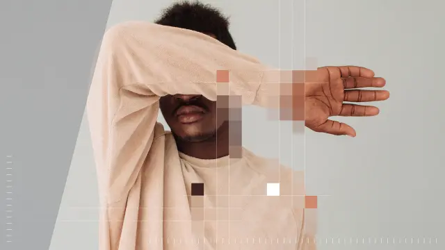 A person covers part of their face with their arm. The image is partially overlaid with colorful pixel blocks.