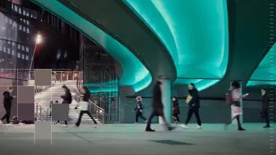 People walk through a modern urban underpass. Parts of the image are overlaid with colorful pixel blocks.