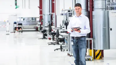 A Bosch associate holding a tablet in his hands.
