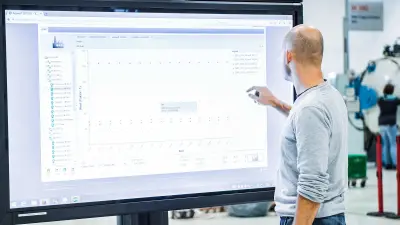 A Bosch associate in front of a big screen.