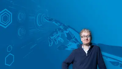 Max Welling in front of a blue background