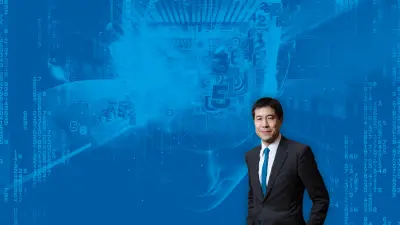 Michael Chui in front of a blue graphic image that shows a face and data codes.
