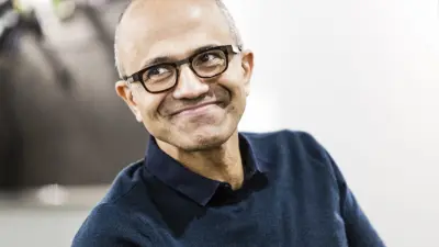 Satya Nadella, CEO of Microsoft, smiles at the camera during an interview.