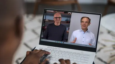 A laptop screen shows Satya Nadella, CEO of Microsoft, and Volkmar Denner, CEO of Bosch, during a joint video call.