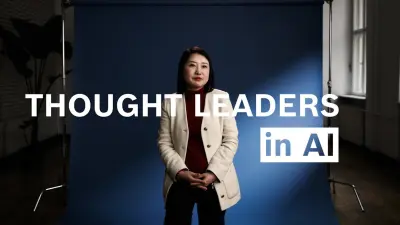 Selina Yuan sits on a chair and speaks into the camera.