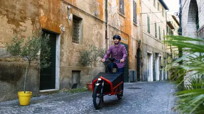 Architect Leonardo Di Chiara rides a Bosch ePowered cargo bike through the old town of an Italian city.
