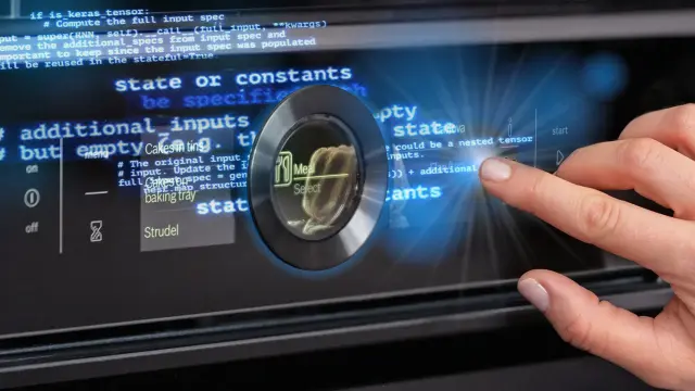 A hand operates the display of an AI oven. The picture again shows a Keras code that creates the digital experience.