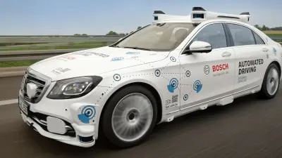 A car equipped with various sensors navigates a test track for autonomous driving.