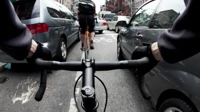 A cyclist in the middle of chaotic traffic