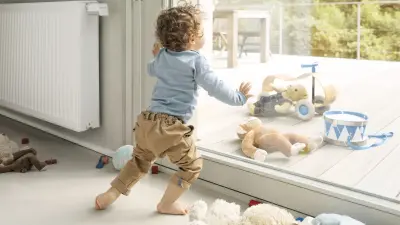 Toddler looking longingly at outdoor toys.