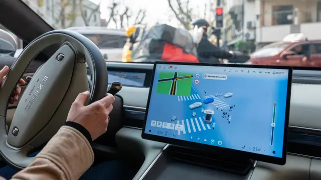 In-car display showing driver assistance system and surrounding traffic