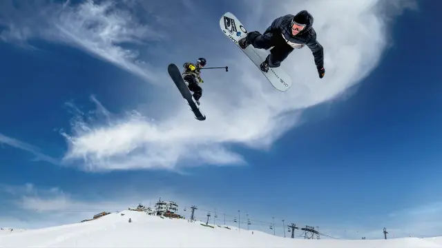 Snowboarders Yanneck Konda and Moritz Amsuess fly through the air, Amsuess films Konda doing a trick with an action cam.