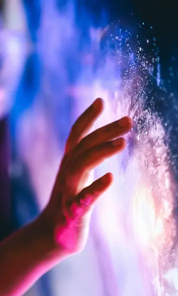A person touching the digital interface - technologies allowing to cross boundaries and enhance our vision on the Universe via Metaverse. 