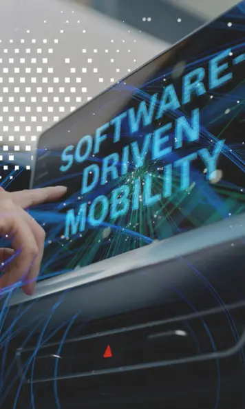A vehicle display showing the large text “SOFTWARE-DRIVEN MOBILITY”