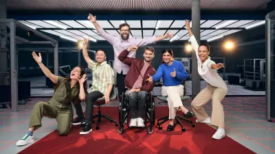 Diverse associates are on a red carpet cheering and having fun