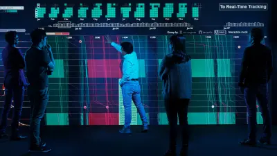 Liu Ren and his team are standing in front of a large display full of data and discussing a data visualization of visual analytics.