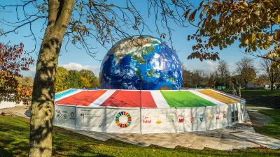 A big globe in a tent in a park