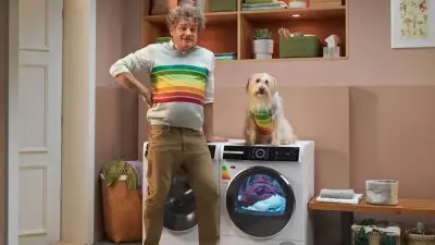 Man, washing machine and dog